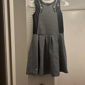 Cute dress with black leather like black material and bling. Very cute!